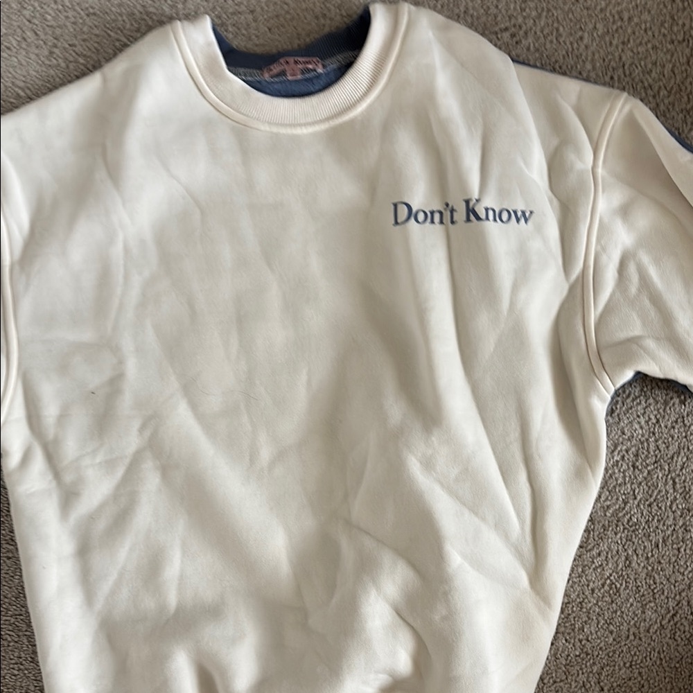 “Don’t know, Don’t care” Cream Sweatshirt with Blue Text